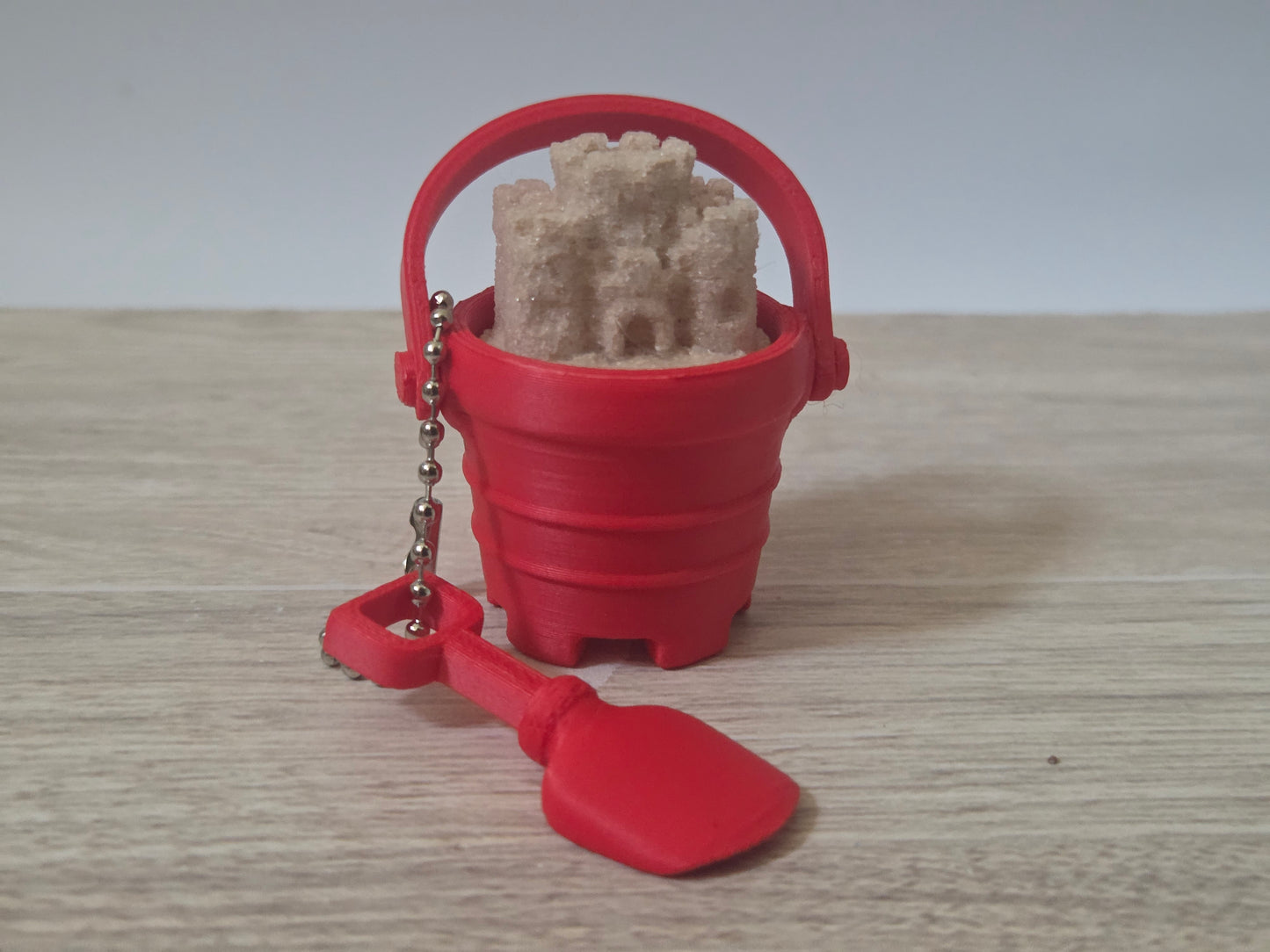 Red sand bucket clicker